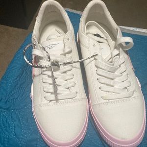 A pair of off white low vulcanized canvas shoes